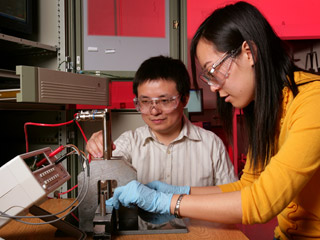 Ph.D. students Liang Zhou and Jingjing Li measuring the deformation of structures joined by adhesive.
